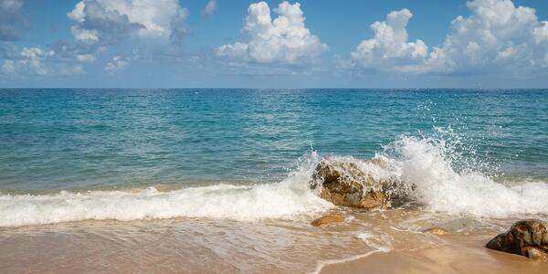 Peaceful seaside view with calm waves and open sky